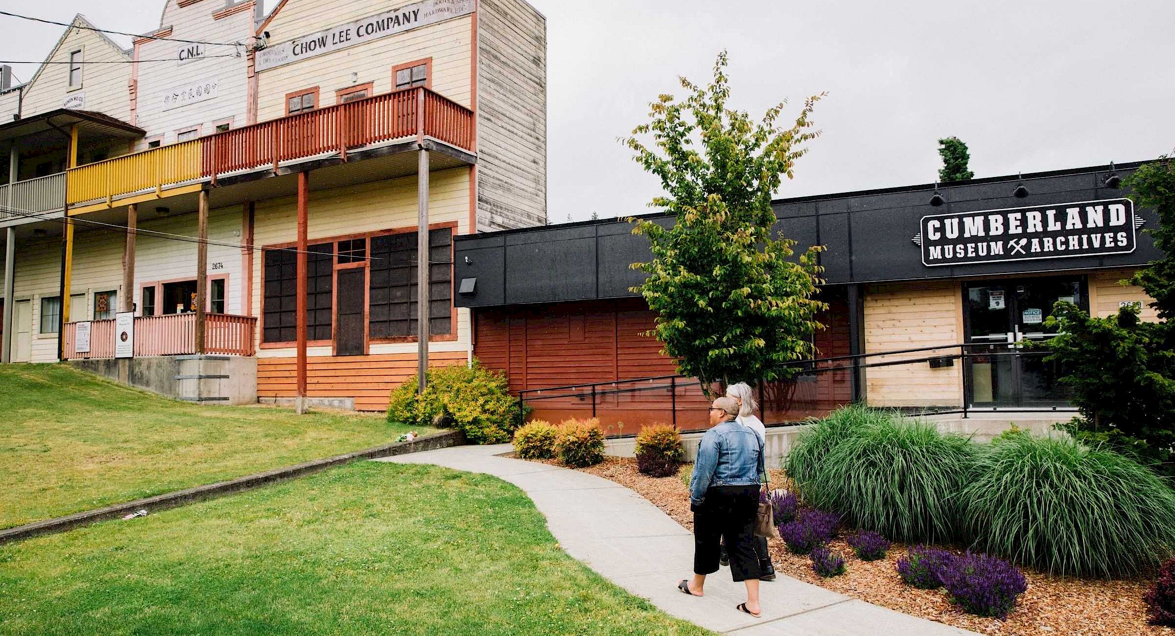 Two people walking up to the Cumberland Archive & Museum