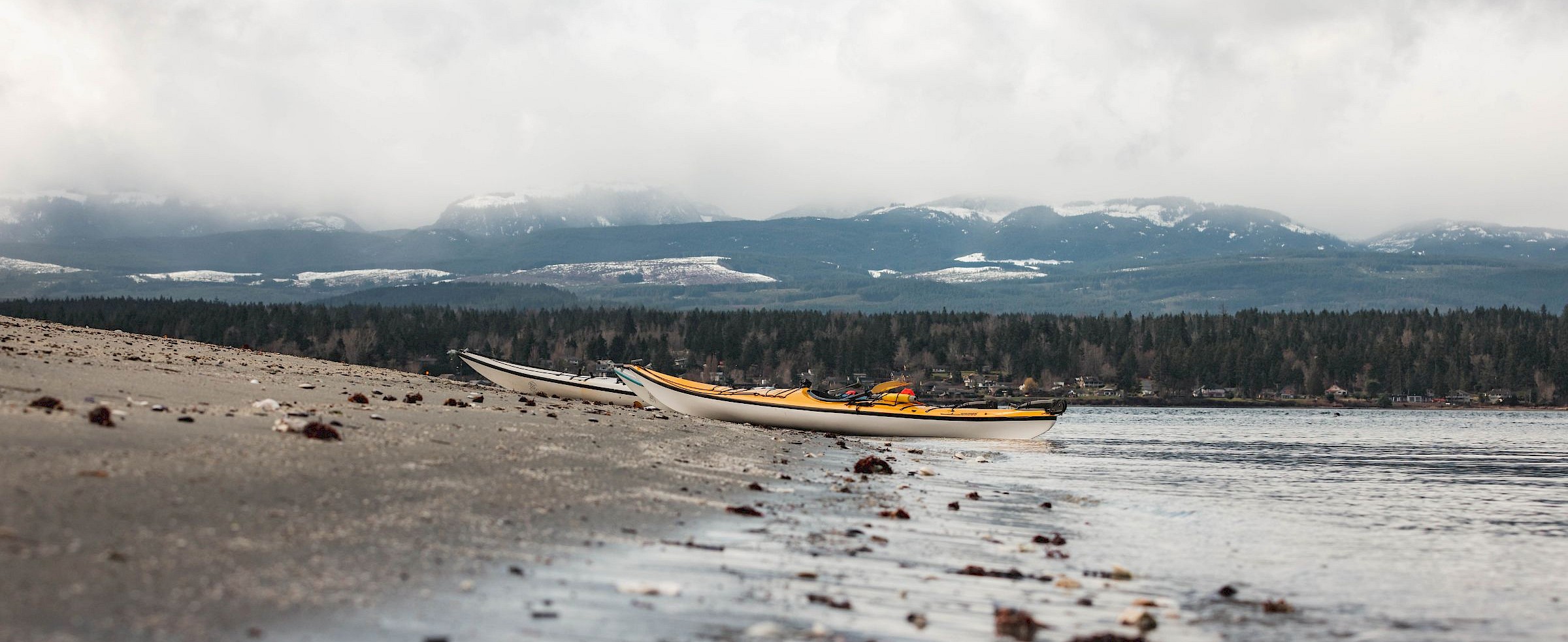 Kayaks along the shore in Comox