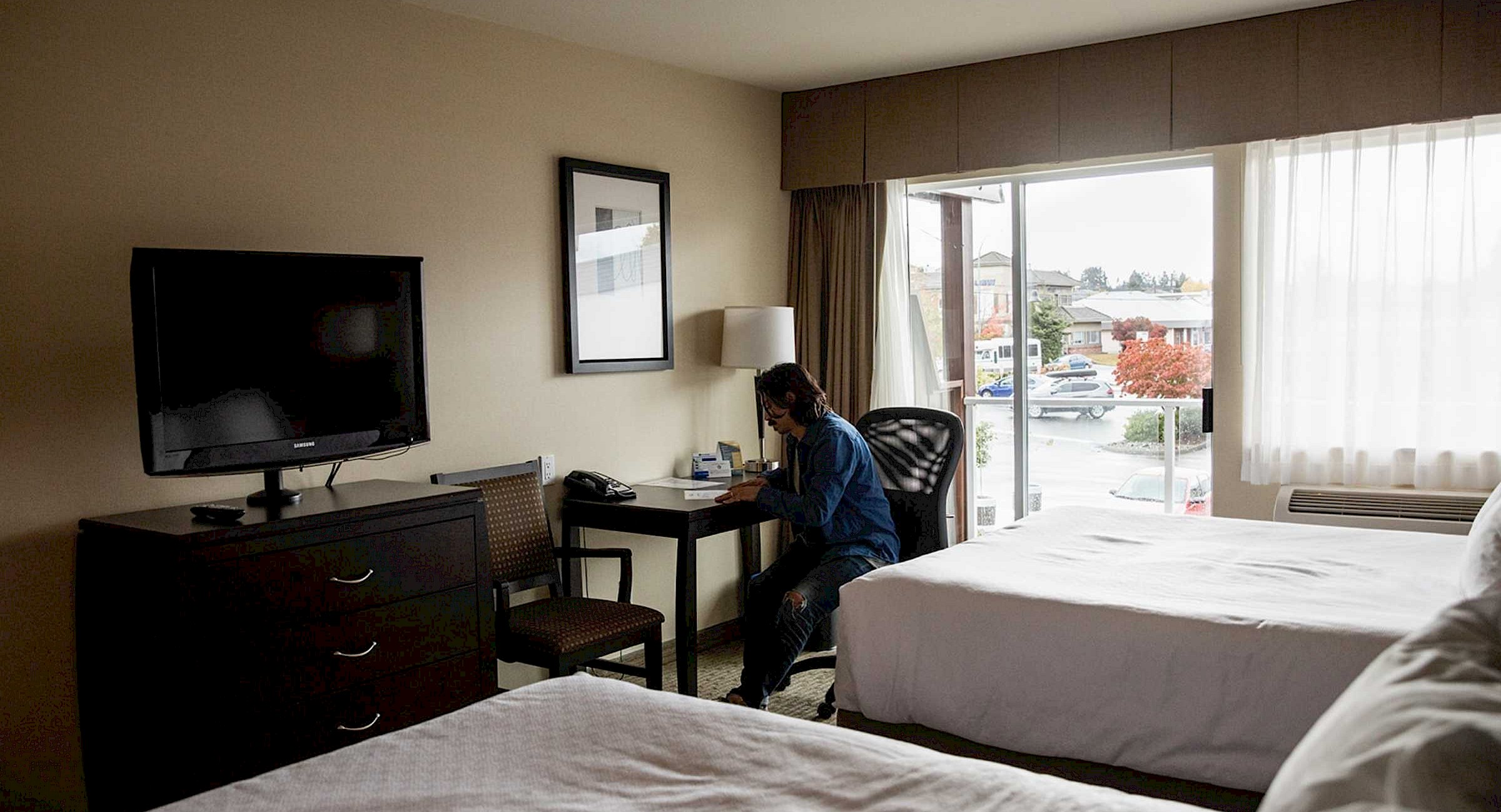 Person sitting at desk in hotel room